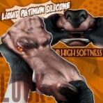 Close-up of gloved hands manipulating a realistic pink-brown silicone prosthetic head against an orange comic-style background, with text about liquid platinum silicone and high softness.