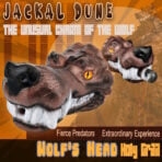 Poster for a creature feature with two snarling jackal-dog heads in the foreground, set against an orange geometric background; large 'JACKAL DUNE' title at the top, with bold subtitle text across the middle and a bottom banner reading 'Fierce Predators' and 'Extraordinary Experience' along with big blocky text 'Wolf's Head Howl'.