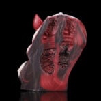 Abstract sculpture with red, gray, and black tones showing organic, ribbed interiors against a black background.