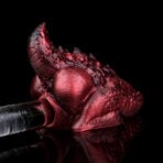Close-up of a glossy red dragon Red Dragon Pocket Pussy Dual Channel Male Masturbator on a transparent wand against a black background.