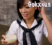 A woman is performing a “gokkun” while holding a cup