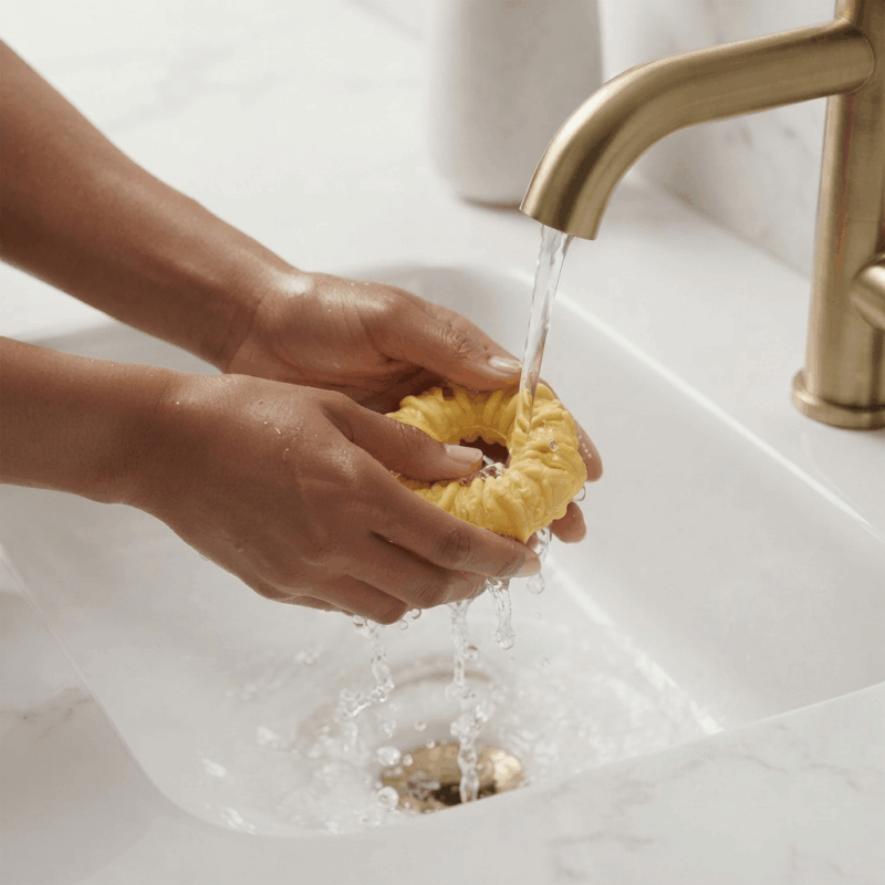 A pair of hands washing a Pocket Pussy